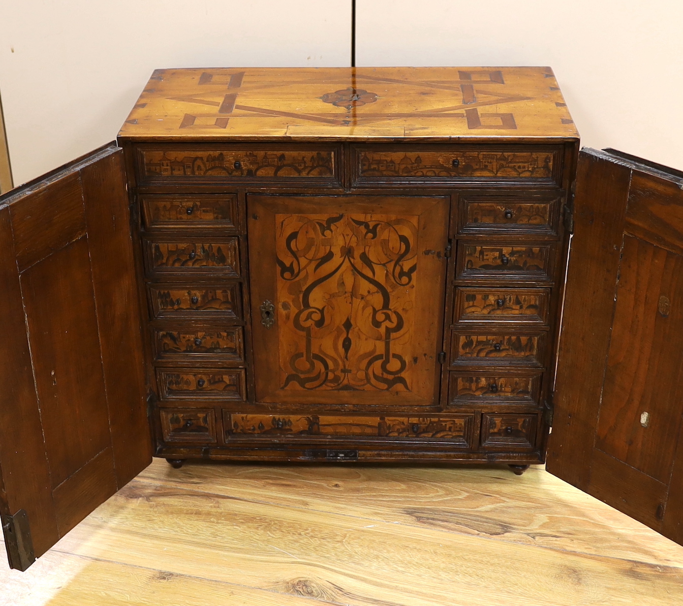 An early 18th century South German marquetry and penwork table top collector's cabinet, 49cm high, 52.5cm wide, 27cm deep